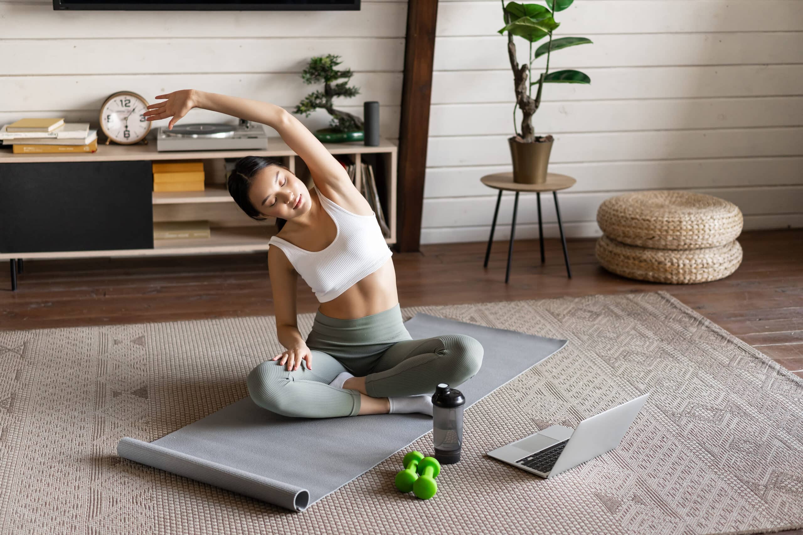 young-asian-fitness-girl-doing-stretching-sport-workout-at-home-stretch-arms-and-looking-at-laptop-f.jpg1 young-asian-fitness-girl-doing-stretching-sport-workout-at-home-stretch-arms-and-looking-at-laptop-f.jpg1